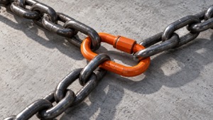 Three steel chains joined by one orange connector, representing interconnected risks managed together